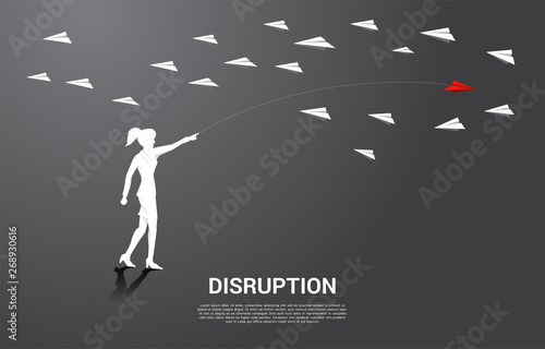 silhouette of businesswoman throw out red origami paper airplane opposite with others white. Business Concept of disruption and entrepreneur