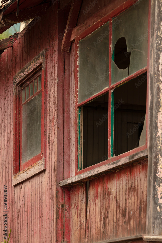 Old abandoned building falling apart with broken windows and doors Old abandoned building falling apart with broken windows and doors