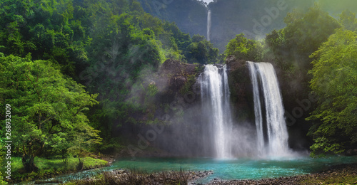 Twin Waterfall Rain Forest In Valley Like A Paradise Garden With Turquoise Green Pond and Blur Waterfall  Mountain Behind. Curug Sodong Amidst Tropical Rain Forest in Global Geopark Ciletuh