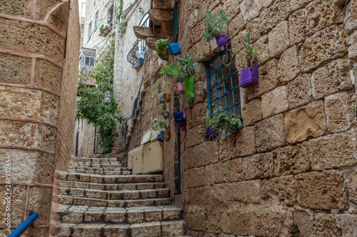 An old city narrow alley with stone walls and stone pavers as stairs