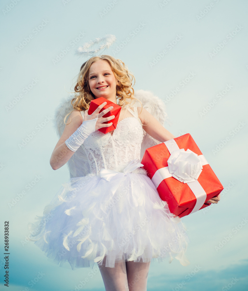 Happy Valentines day. Present gift from angel. Cherub angel girl teen with gift for your. Child with angelic character. Concept of Valentines Daygirl dressed as an angel on a light background. Happy Valentines day. Present gift from angel. Cherub angel girl teen with gift for your. Child with angelic character. Concept of Valentines Daygirl dressed as an angel on a light background.