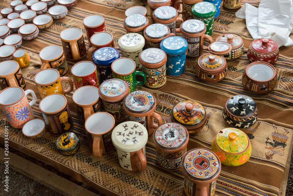 Multicolored handmade pots at a stall selling handicrafts in Chinchero, Sacred Valley, Peru