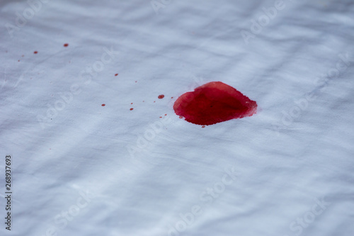 Drops of blood on a white cloth