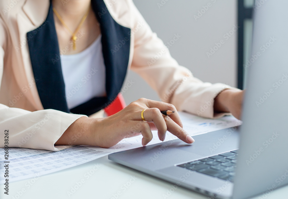 Businessman hands busy using laptop at office desk, young female student typing on computer sitting at wooden table Businessman hands busy using laptop at office desk, young female student typing on computer sitting at wooden table