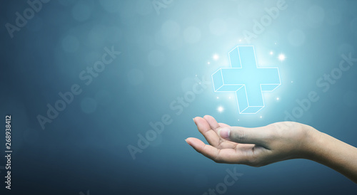 Hand holding plus sign virtual means to offer positive thing (like benefits, personal development, social network, health insurance) with copy space
