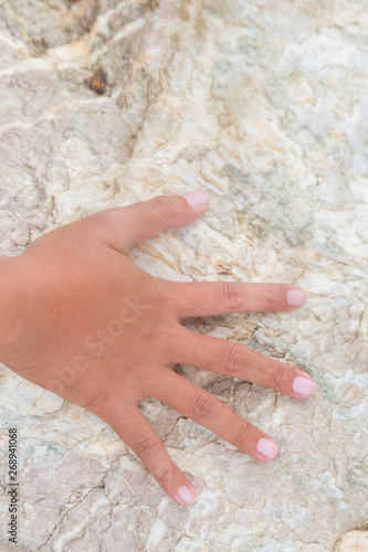 Woman hand touch on the stone