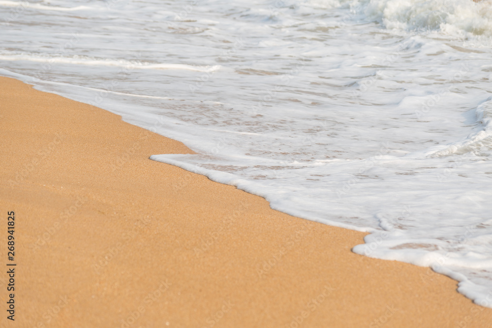 Soft foam wave and sea on the sandy beach