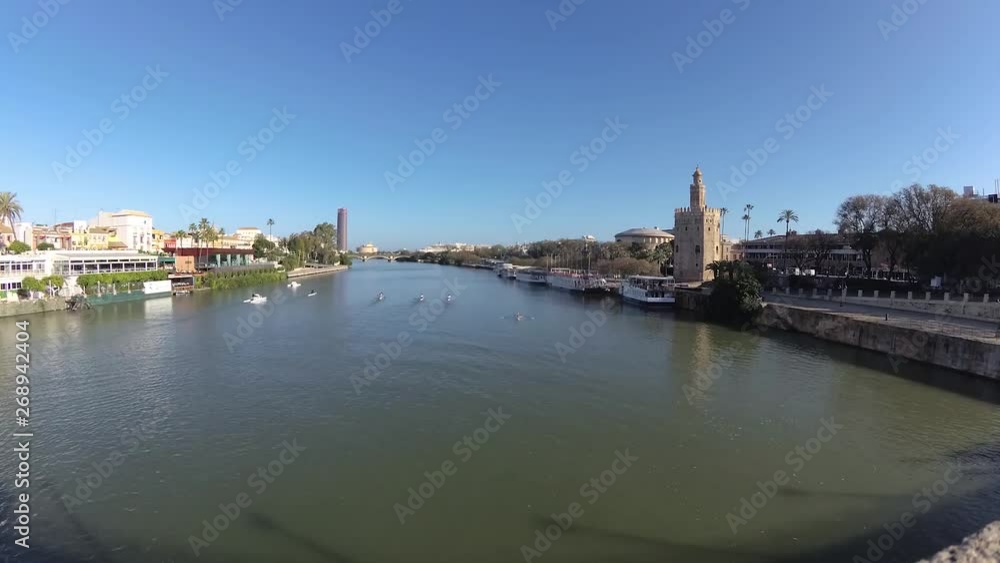 Boat sailing over the Guadalquivir River, Seville, Spain Boat sailing over the Guadalquivir River, Seville, Spain