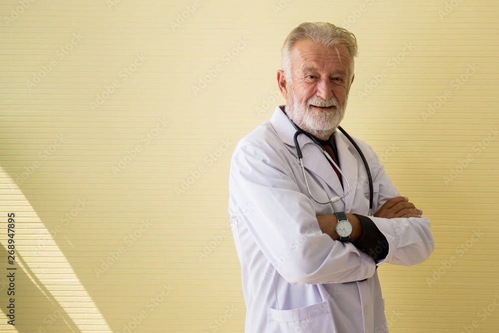 Portrait of senior doctor standing and cross arms looking camera at hospital,Happy and positive thinking attitude,Copy space for text Portrait of senior doctor standing and cross arms looking camera at hospital,Happy and positive thinking attitude,Copy space for text