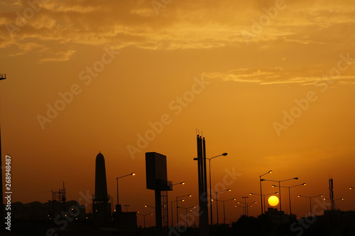 Sunset over city with buildings in Silhouette