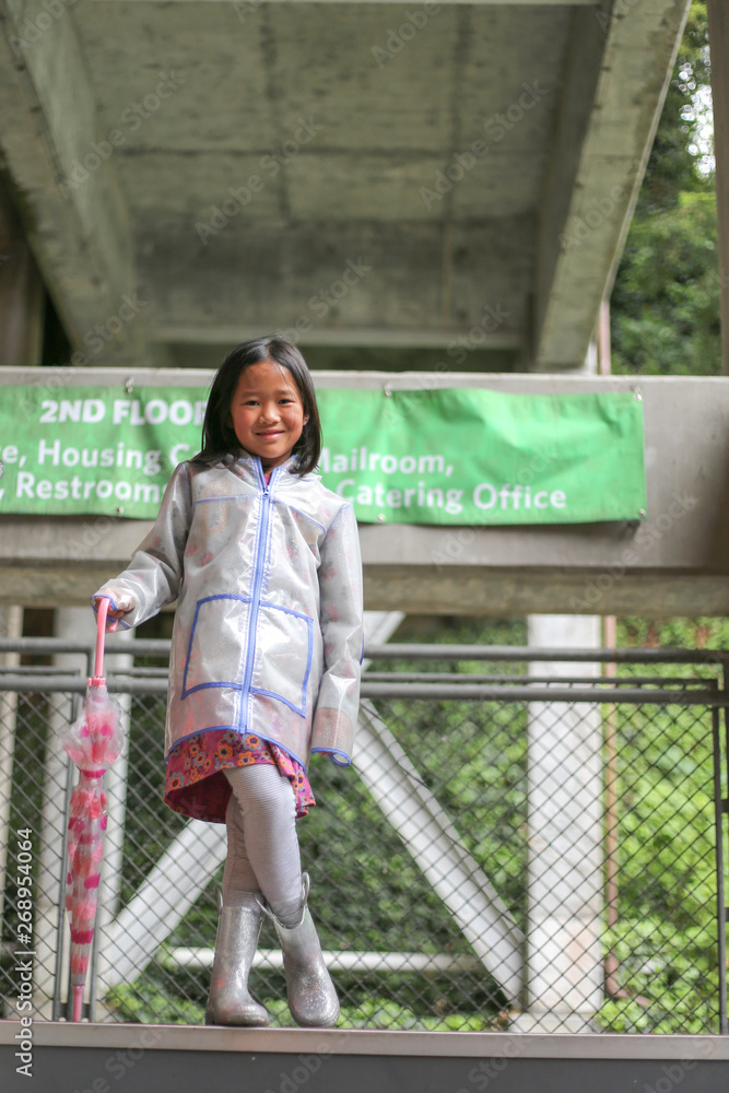 Little girl wearing rain gear on stairway Stock Photo Adobe Stock