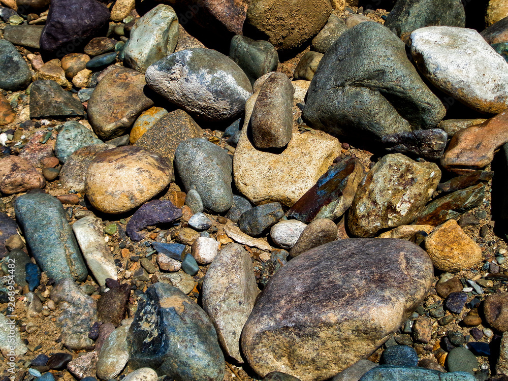 Stones on the ground. Rock background. Ground and stones. Rocky soil. Stone background. Natural Stones on the ground. Rock background. Ground and stones. Rocky soil. Stone background. Natural