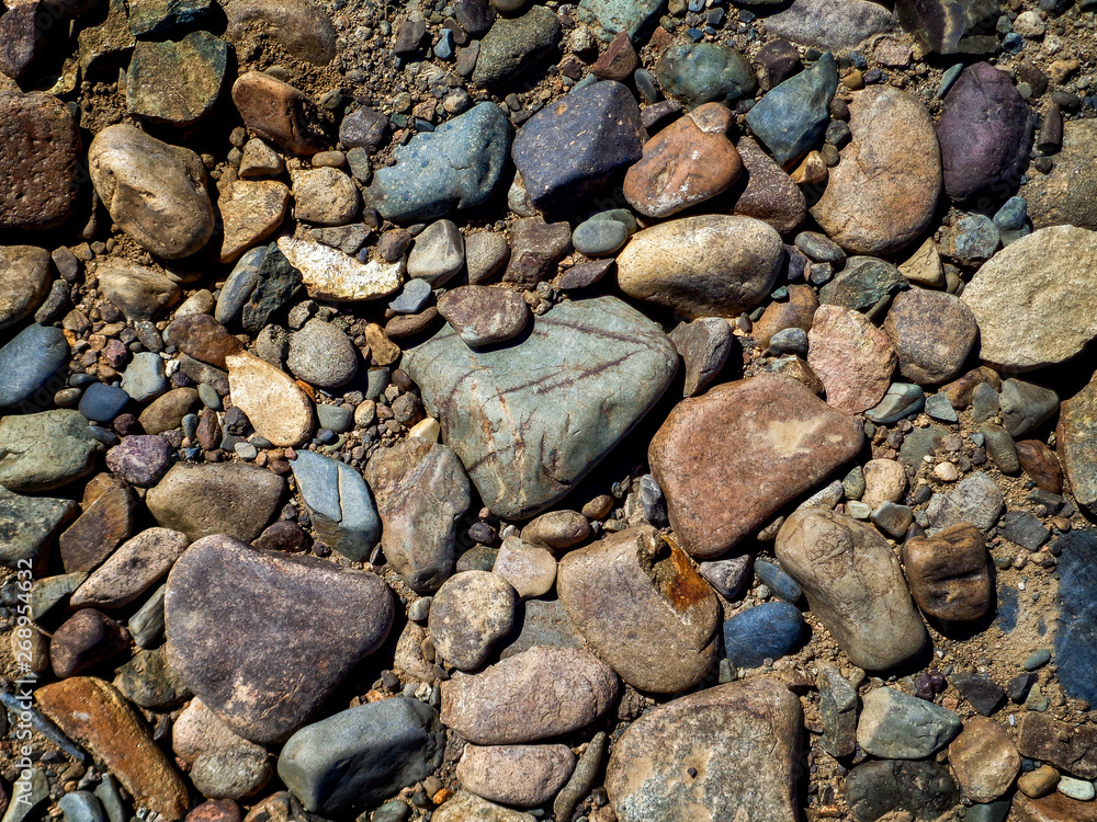 Stones on the ground. Rock background. Ground and stones. Rocky soil. Stone background. Natural Stones on the ground. Rock background. Ground and stones. Rocky soil. Stone background. Natural
