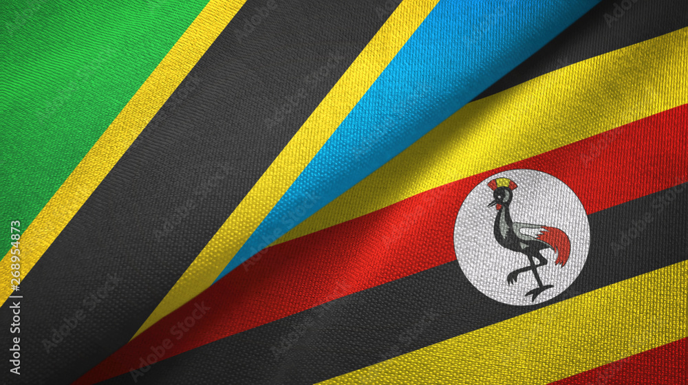 Fototapeta premium Tanzania and Uganda two flags textile cloth, fabric texture