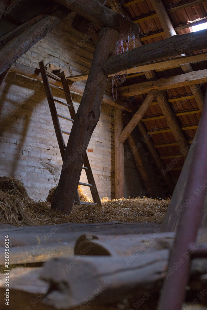Wooden barn with hay and a ladder