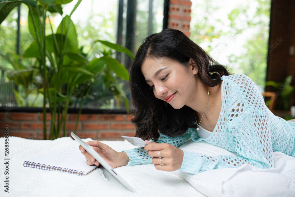 happy young woman with pen and notebook writing in bed at home bedroom happy young woman with pen and notebook writing in bed at home bedroom