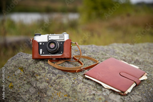 Retro camera. Traveler baggage and retro camera with copy space. Top view.