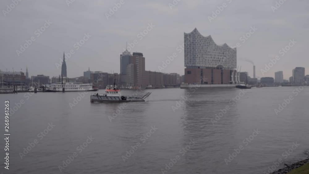 Dredging ship on Elbe river at Elbphilharmonie in Hamburg Dredging ship on Elbe river at Elbphilharmonie in Hamburg