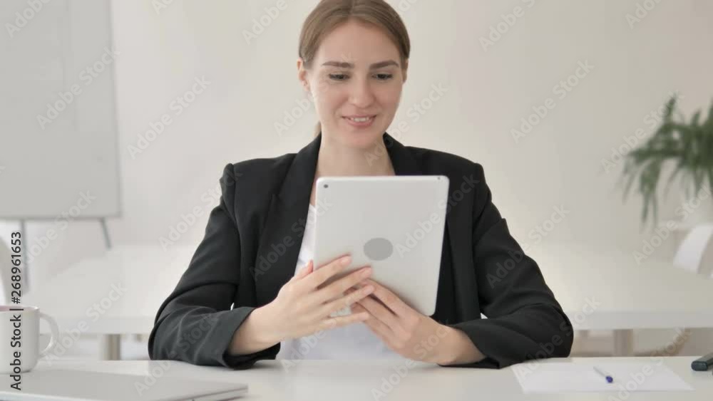 Online Video Chat on Tablet by Young Businesswoman Online Video Chat on Tablet by Young Businesswoman