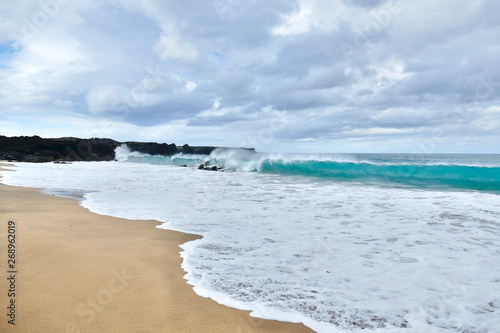 Turquoise ocean waves at golden beach on Snaefellsnes peninsula photo