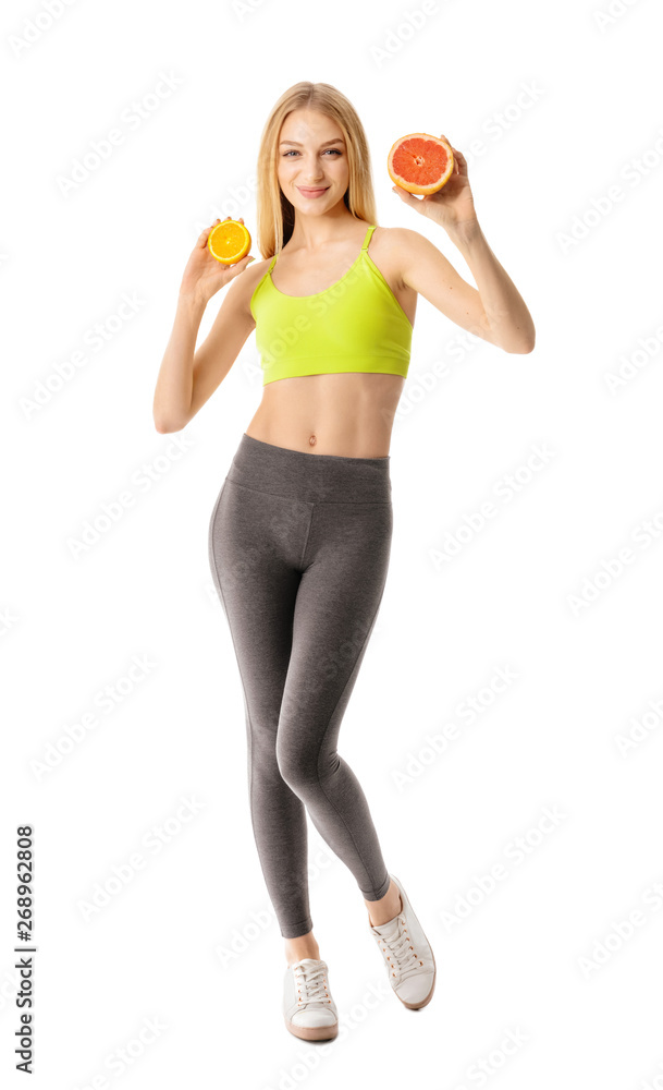 Sporty young woman with citrus fruits on white background Sporty young woman with citrus fruits on white background