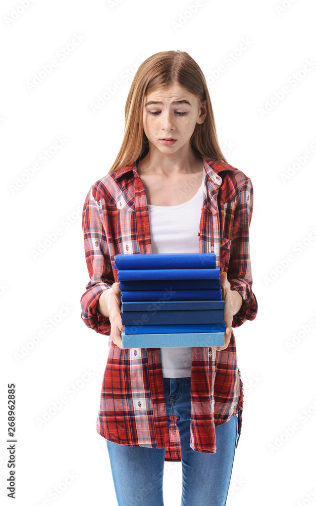 Stressed teenage girl with a lot of books on white background Stressed teenage girl with a lot of books on white background