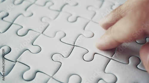 last piece of white plain jigsaw holding by hand, step of success concept