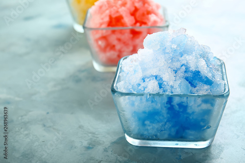 Foto Bowl with tasty shaved ice on color background