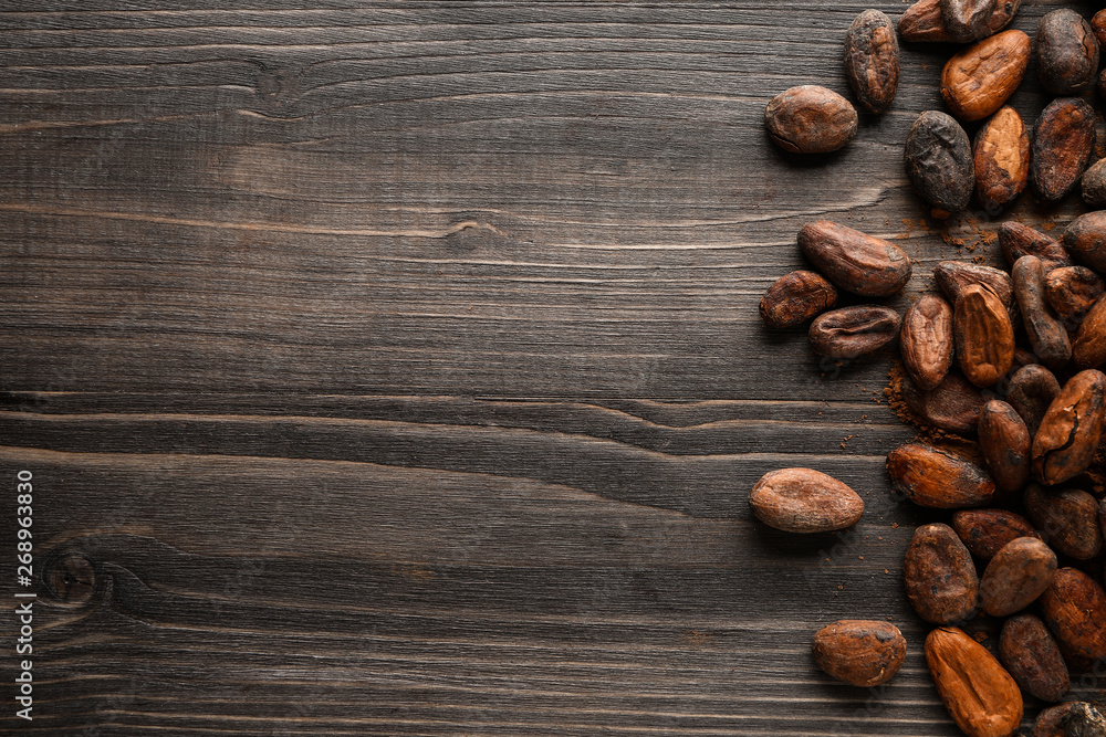 Cocoa beans on wooden background Cocoa beans on wooden background
