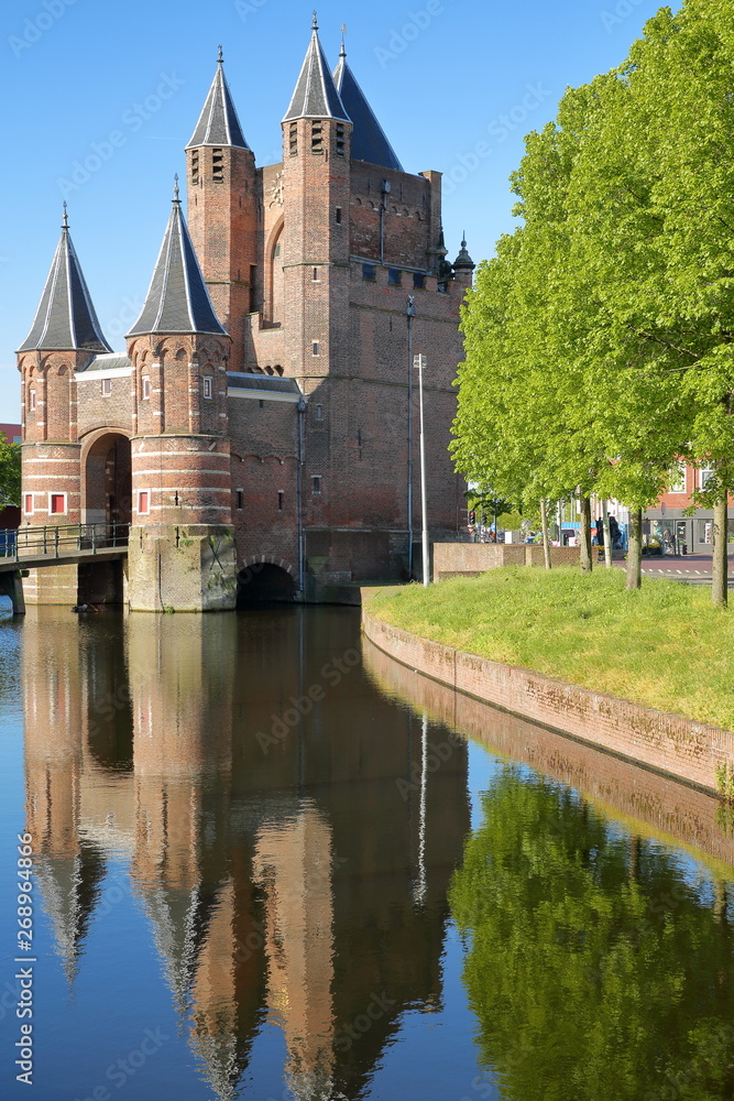 Reflections of the Amsterdamse Poort city gate (built between 1400 and 1500) in Haarlem, Netherlands