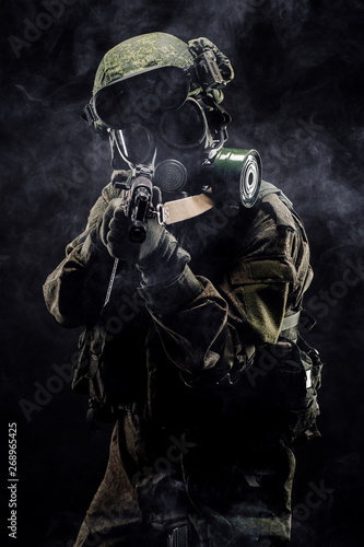 russian special forces soldier with rifle on dark background. army  military and people concept