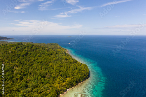 Green island with coral reef. Coast of Camiguin Island, Philippines, view from above. Seascape in sunny weather. © Tatiana Nurieva