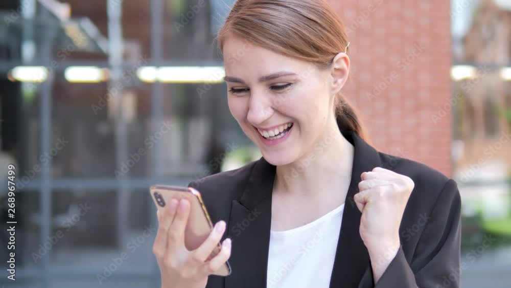 Outdoor Young Businesswoman Excited for Success on Smartphone Outdoor Young Businesswoman Excited for Success on Smartphone
