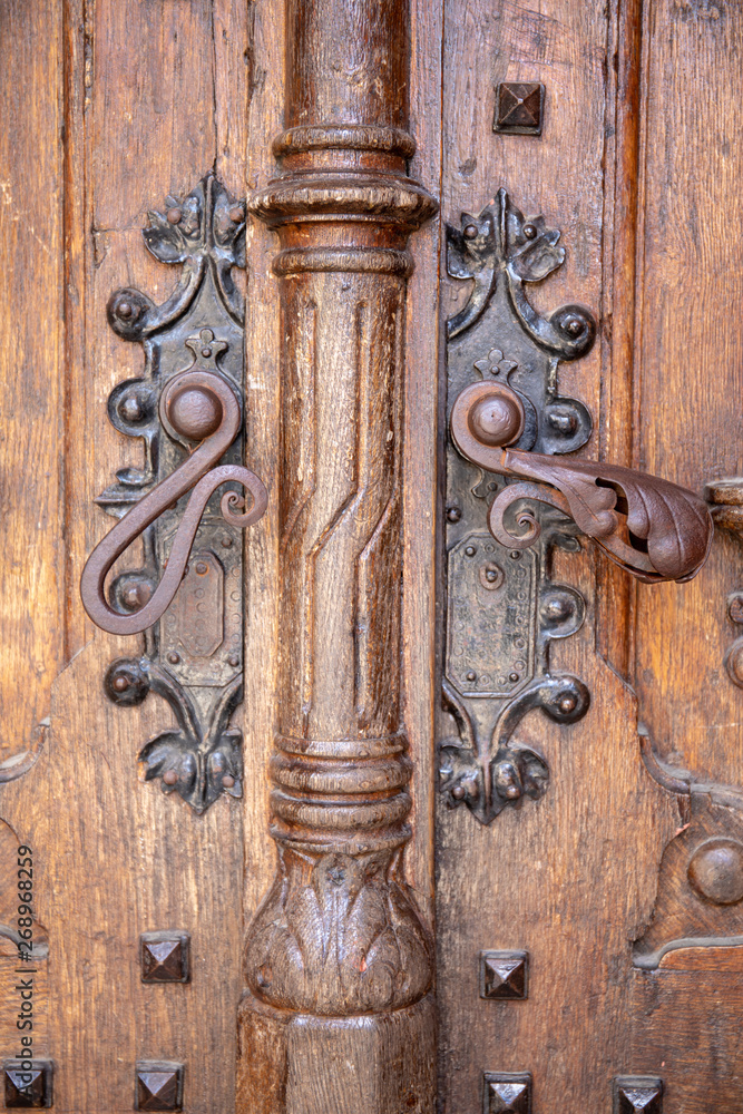 Old wooden entrance door with antique door handle Old wooden entrance door with antique door handle