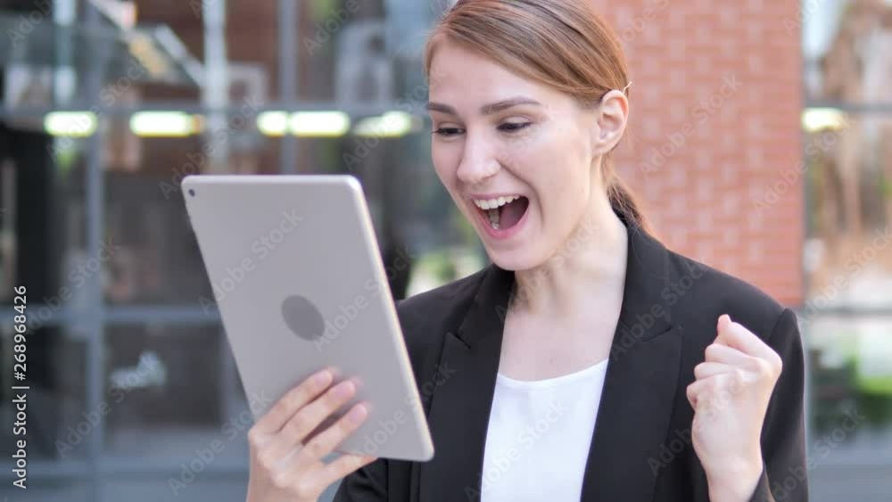 Young Businesswoman Cheering for Success on Tablet Outdoor Young Businesswoman Cheering for Success on Tablet Outdoor