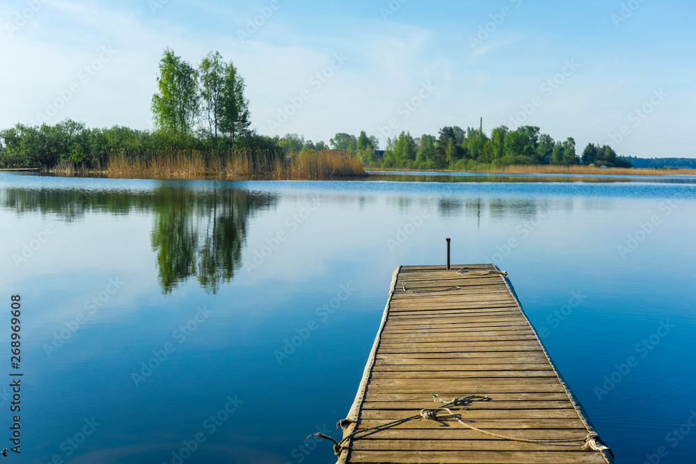 Landscape with the image of pier on lake Seliger in Russia