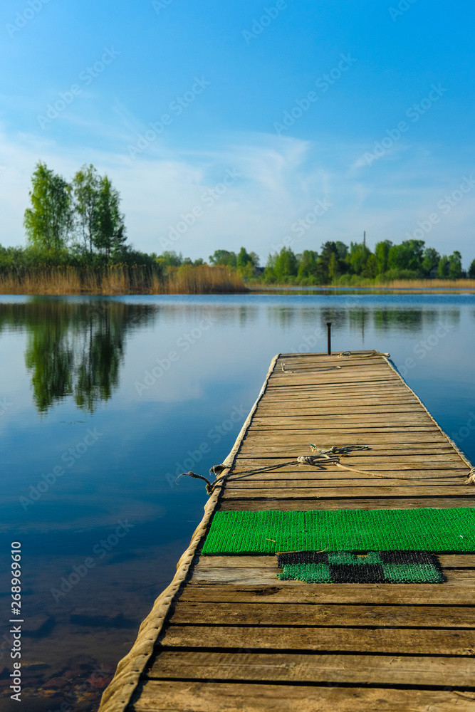 Landscape with the image of pier on lake Seliger in Russia