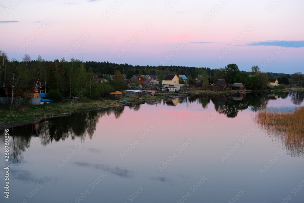 Landscape with the image of village on lake Seliger in Russia