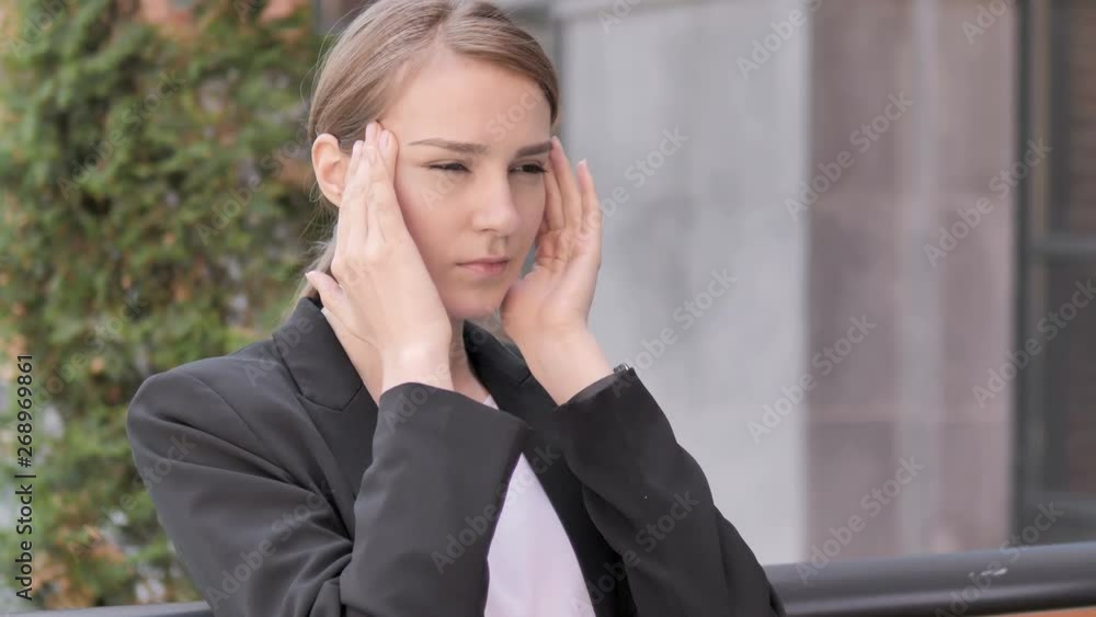 Stressed Young Businesswoman with Headache Sitting Outdoor Stressed Young Businesswoman with Headache Sitting Outdoor