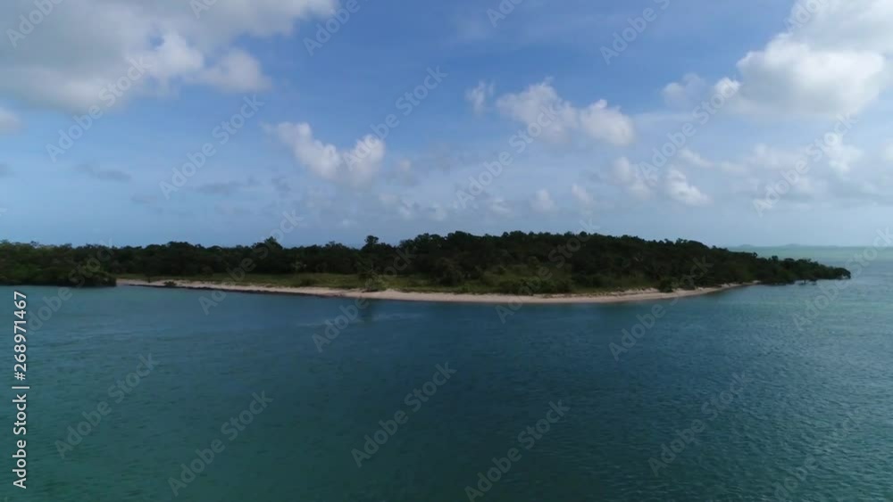 Drone flies towards a small deserted island of the coast of Seisia in far north Queensland. Drone flies towards a small deserted island of the coast of Seisia in far north Queensland.