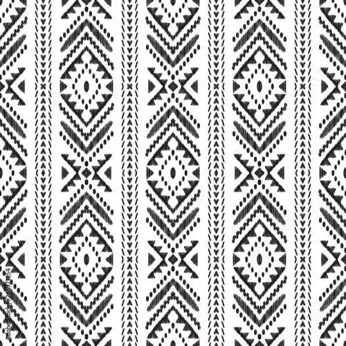 Chevron seamless pattern. Black textured tribal elements on the white background. Ethnic design in modern aztec, navajo, boho style. Ikat wallpaper. Vector illustration.