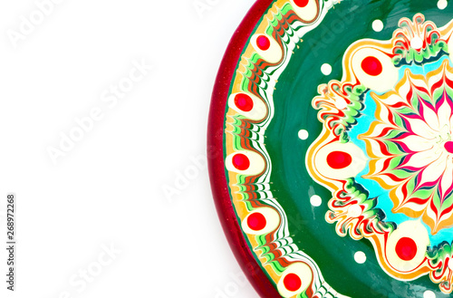 Bulgarian traditional plate, souvenir decorated dish with Balkan floral ornament. Isolated on white background.
