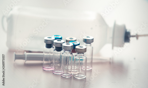 Medical background with syringe and vaccine bottles