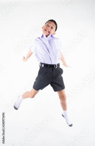 Little Asain boy in student uniform on white background