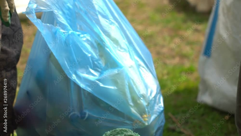 Young team of multiethnical volunteers cleaning up the forest. Safe ecology concept. Sort garbage. Young team of multiethnical volunteers cleaning up the forest. Safe ecology concept. Sort garbage.