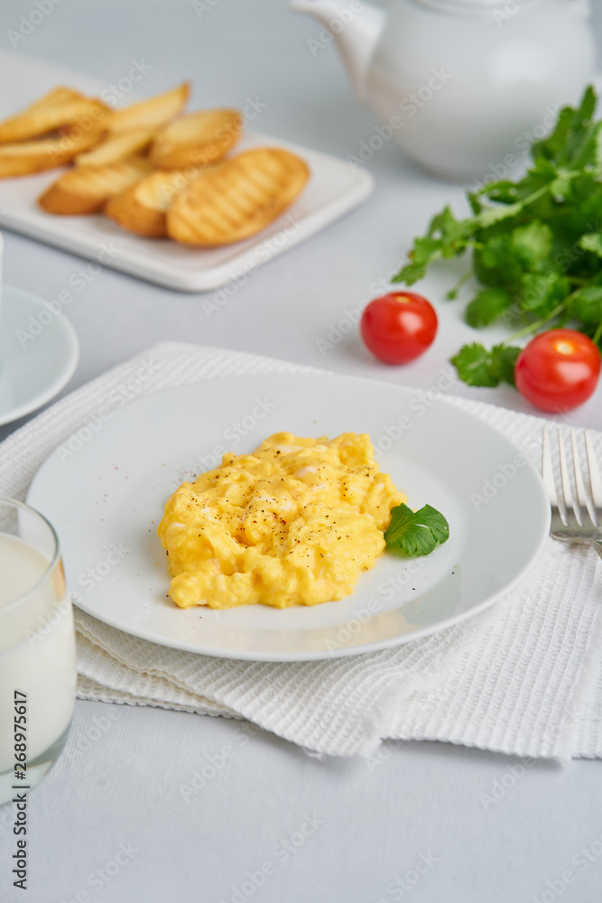Scrambled eggs, Omelette. Breakfast with pan-fried eggs, glass of milk, tomatoes on white background. Vertical Scrambled eggs, Omelette. Breakfast with pan-fried eggs, glass of milk, tomatoes on white background. Vertical