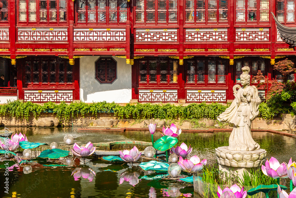 Beautiful woman sculpture in the pond of Yuyuan garden in old Shanghai, China. Summer sunny day