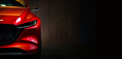 Red modern car headlights on black background 