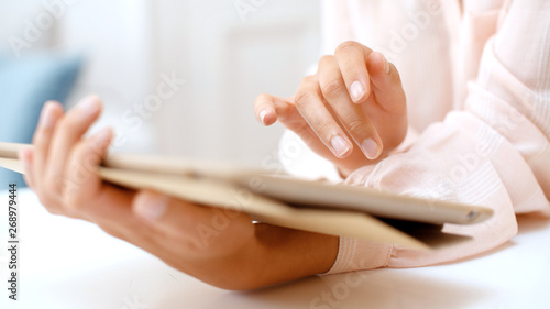 Close up of woman or student girl with tablet pc computer at home.