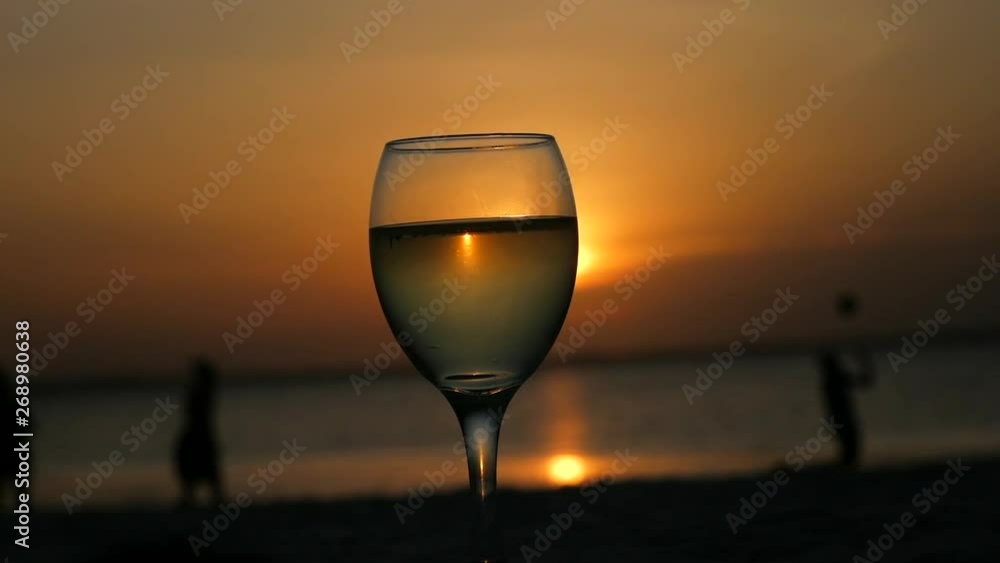 Drinking a glass of wine on the Indian Ocean with beautiful a beautiful sunset. Drinking a glass of wine on the Indian Ocean with beautiful a beautiful sunset.